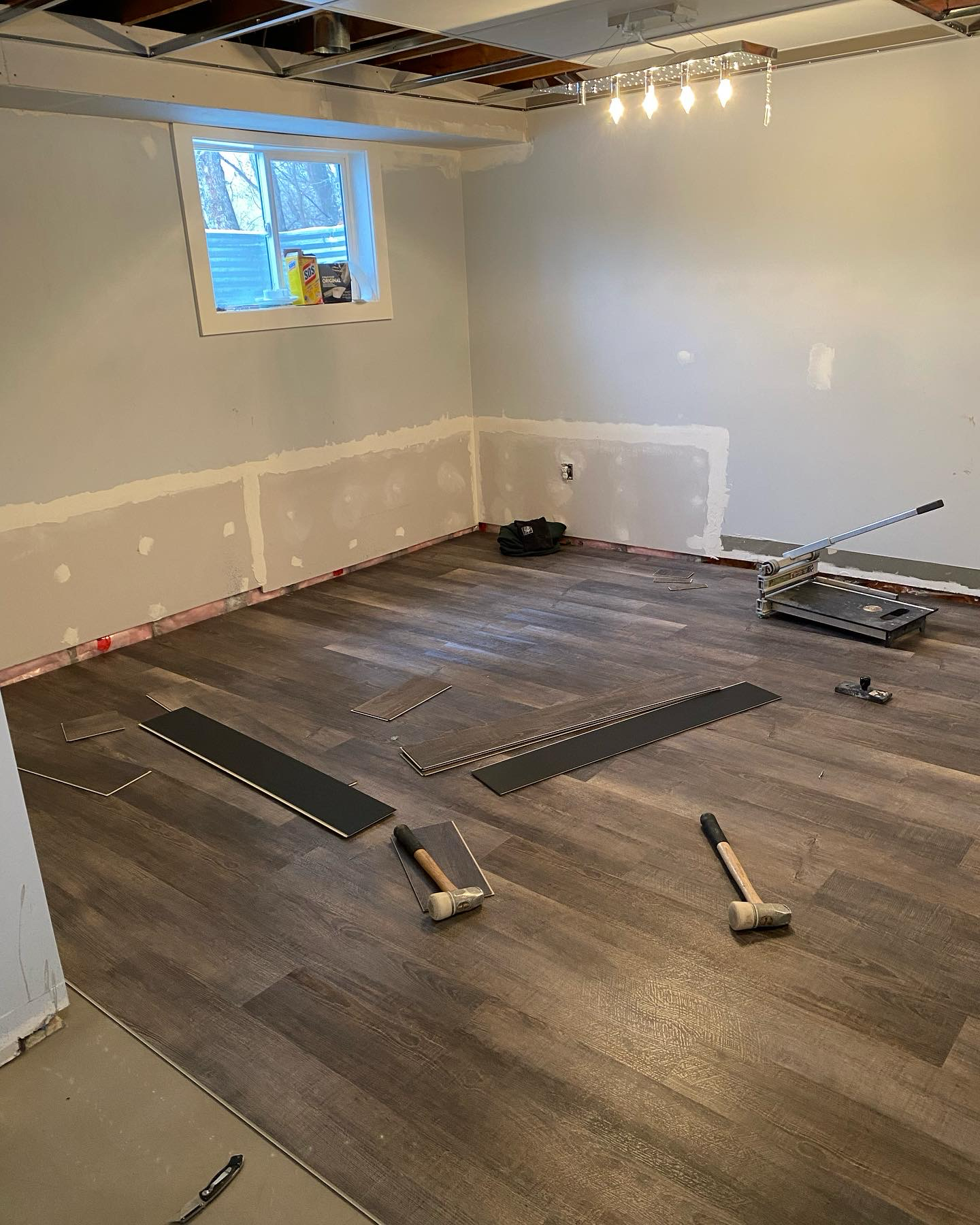 flooring installation at a residential basement renovation. Residential contractor project by FLOW Contractors